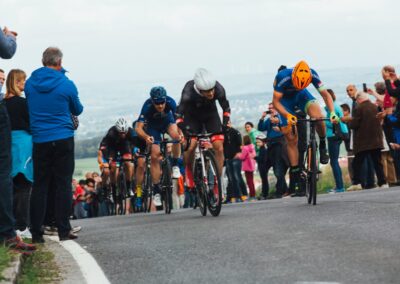 people riding bicycle on road during daytime