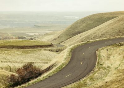 A winding road in the middle of a hilly area